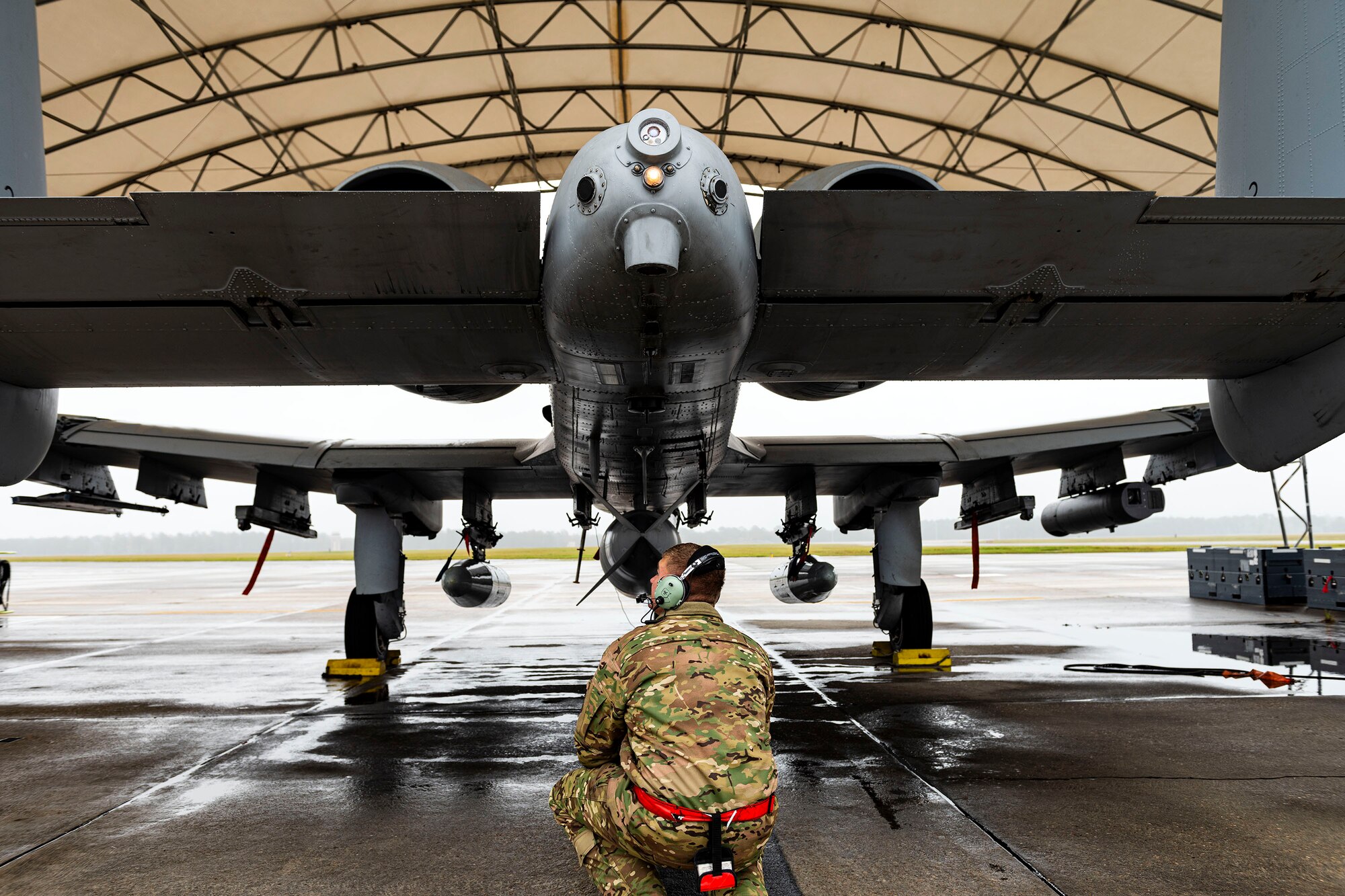 A photo of an Airman checking flight controls