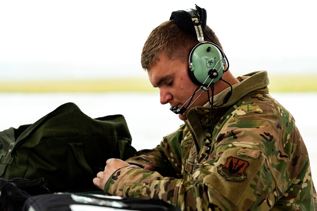 A photo of an Airman reviewing technical orders for an aircraft.