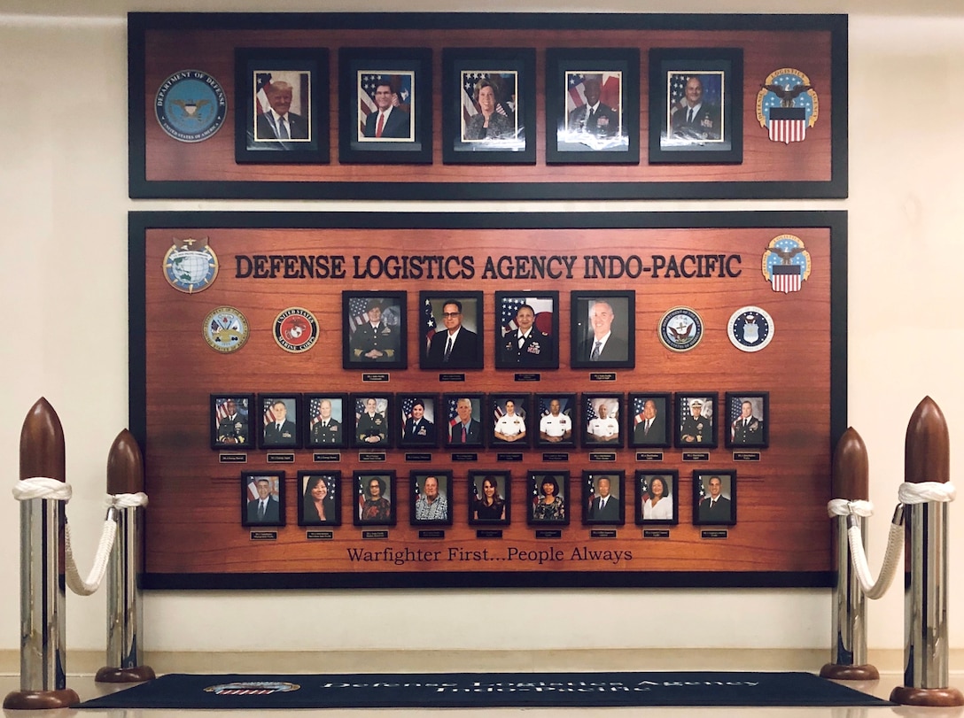 A photo board with the portraits of everyone who supports DLA Indo-Pacific