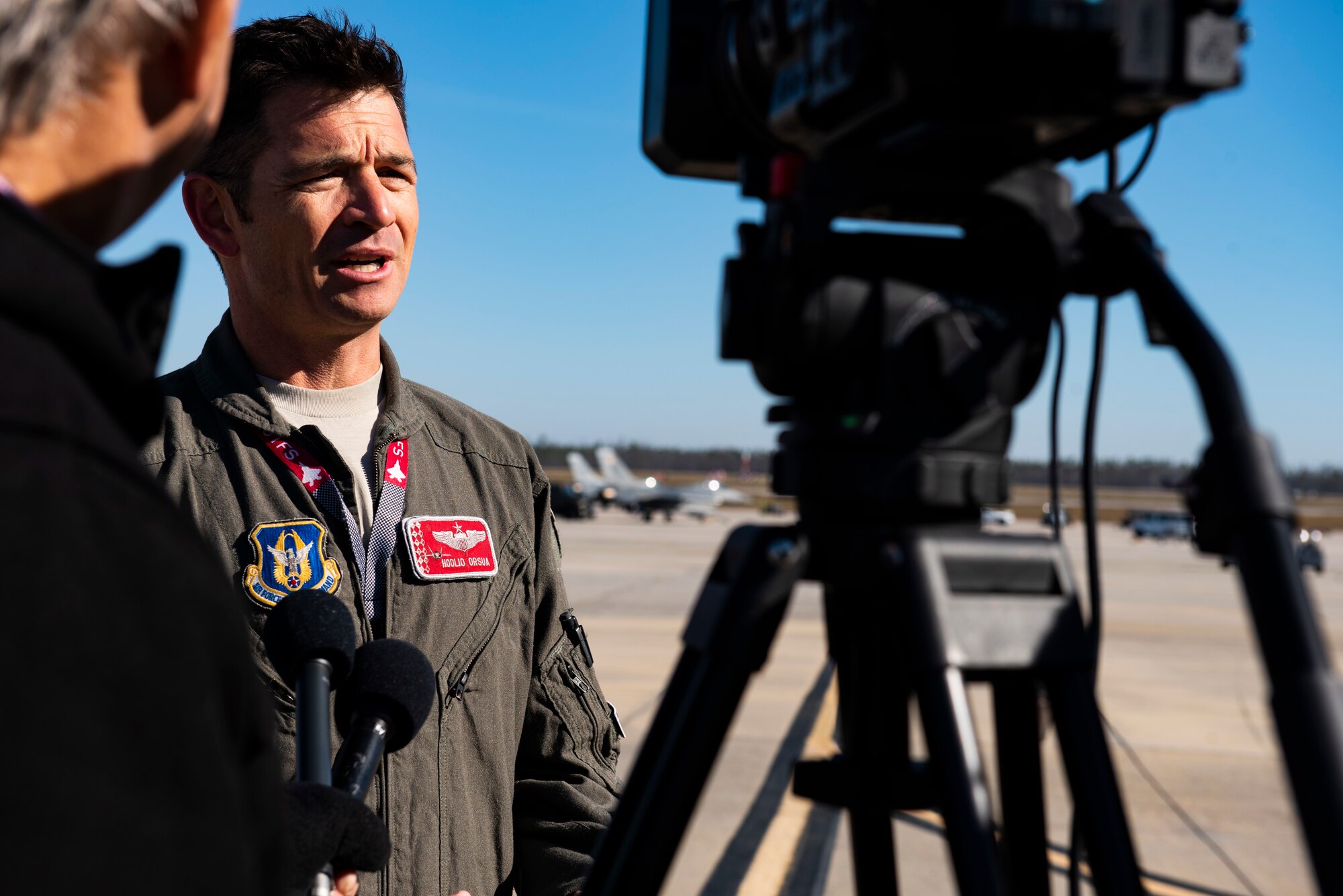 Lt. Col. Benjamin Orsua, Checkered Flag 20-1 exercise director, is interviewed by local media stations at Tyndall Air Force Base, Florida, Nov. 13, 2019. Checkered Flag is a large-scale exercise involving multiple military partners and installations, designed to focus on training and evaluating fourth and fifth-generation fighter aircraft, pilots and maintainers. In conduction with the exercise, air-to-air and air-to-ground combat operations are tested and recorded to provide data on best practices and ensuring future mission successes. (U.S. Air Force photo by Staff Sgt. Magen M. Reeves)