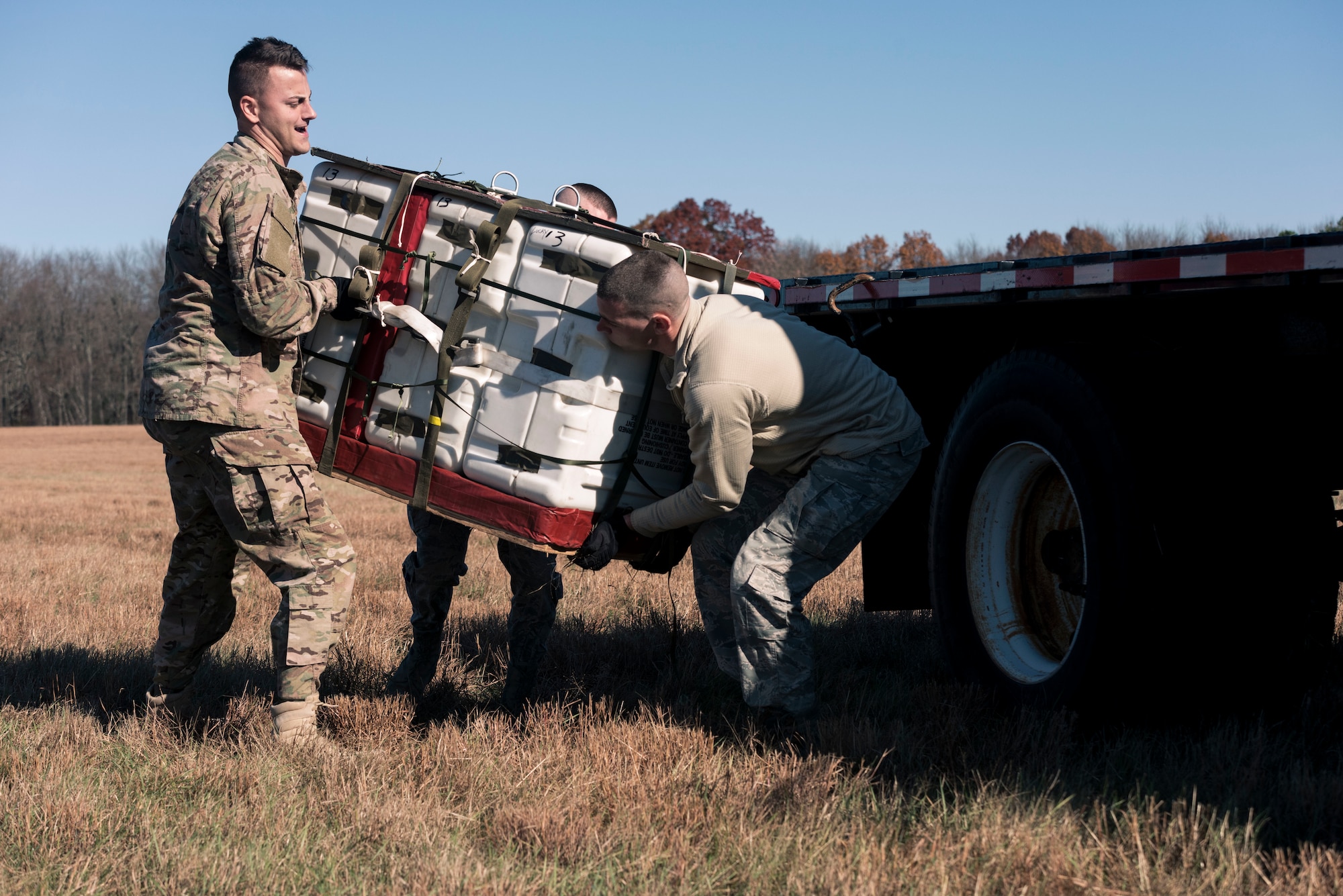 Airmen assigned to the assigned to the 103rd Logistics Readiness Squadron load a recovered cargo pallet onto a flatbed truck at Westover Air Reserve Base, Chicopee, MA. Nov. 2, 2019. Local airdrop missions keep 103rd Operations Group aircrews and 103rd Logistics Readiness Squadron air transportation specialists current on their training requirements. (U.S. Air National Guard photo by Airman 1st Class Chanhda Ly)
