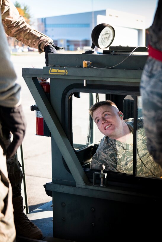 Senior Airman Sean Manierre, 103rd Logistics Readiness Squadron air transportation specialist, checks for visibility while driving a Next Generation Sequential Loader at Bradley Air National Guard Base, East Granby, Conn. Nov. 2, 2019, The loader, also called a 25k, is a large loading platform used to transport cargo onto aircrafts. (U.S. Air National Guard photo by Airman 1st Class Chanhda Ly)