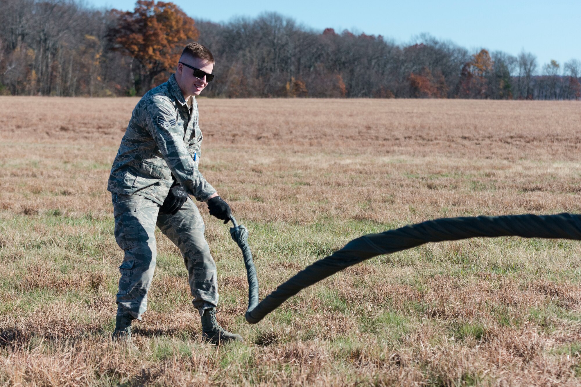 Senior Airman Sean Manierre, 103rd Logistics Readiness Squadron air transportation specialist, repacks a parachute after an airdrop at Westover Air Reserve Base, Chicopee, Mass. Nov. 2, 2019. The parachute used for the air drop is part of a low-cost, low-altitude pallet and can be thrown away after use. (U.S. Air National Guard photo by Airman 1st Class Chanhda Ly)