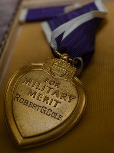 Inscription of the name of Lt. Col. Robert G. Cole on the back of the Purple Heart medal awarded to him posthumously 75 years ago shown after a Veterans Day observance ceremony at the Cole High School gymnasium Nov. 8. The Purple Heart medal made its way to the school named after Cole because of the efforts of Lisa Ludwig, a Long Island, New York resident who found and purchased the medal at a gun show and donated it to the school