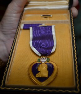 The front part of the Purple Heart medal awarded posthumously to Lt. Col. Robert G. Cole 75 years ago shown after a Veterans Day observance ceremony at the Cole High School gymnasium Nov. 8. The Purple Heart medal made its way to the school named after Cole because of the efforts of Lisa Ludwig, a Long Island, New York resident who found and purchased the medal at a gun show and donated it to the school.