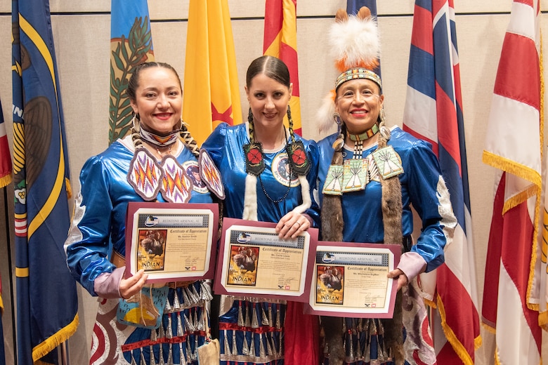 Three members of the Native American Women Warriors stand together with their certificates of appreciation at the National American Indian Heritage Month observance at Redstone Arsenal, Alabama, Nov. 13, 2019. From left to right: Army veteran Keshon Smith; Marine Corps veteran Carrie Lewis; and Army veteran Mitchelene BigMan, president and founder of NAWW. The observance was organized by Huntsville Center’s Equal Employment Opportunity office in coordination with Team Redstone and the U.S. Army Aviation and Missile Command. The Native American Women Warriors are an all-female group of Native American veterans who started as a color guard but have since grown and branched out as advocates for Native American women veterans in areas such as health, education and employment. The members make appearances at various events around the country, serving as motivational and keynote speakers, performing tribal dances, and fulfilling the role of color guard representing all branches of the U.S. military.