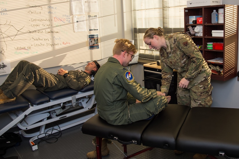U.S. Air Force Capt. Michelle Jilek, 633rd Medical Operations Squadron physical therapist, examines Capt. Breck Stewart, 71st Fighter Squadron T-38 Talon pilot, for injuries at Joint Base Langley Eustis, Virginia, Nov. 13, 2019.