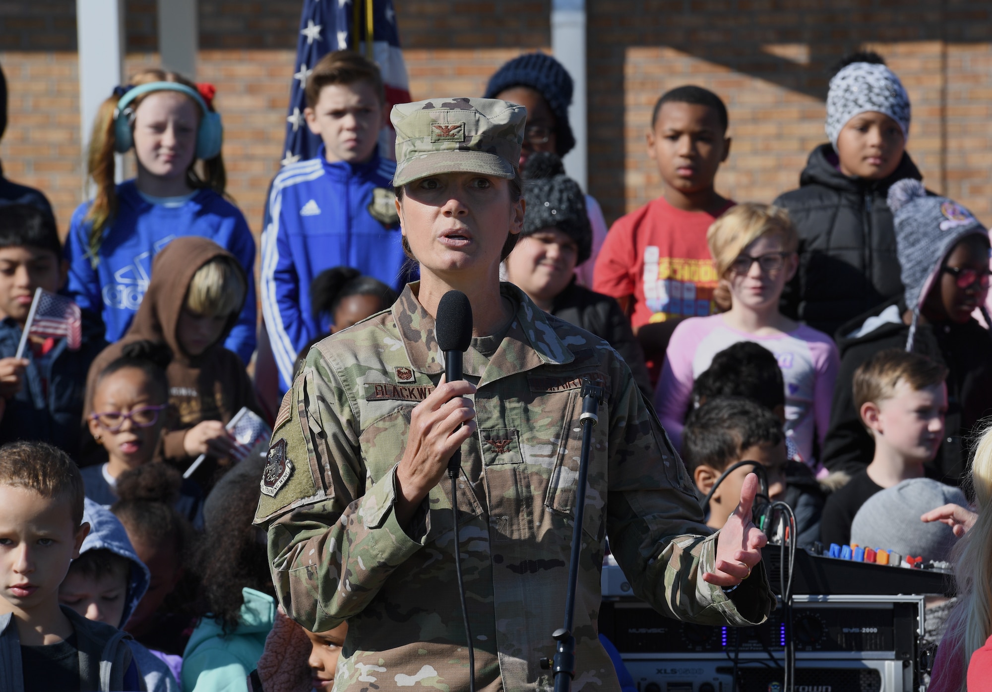 U.S. Air Force Col. Heather Blackwell, 81st Training Wing commander, delivers remarks during a Jeff Davis Elementary School Veterans Day celebration in Biloxi, Mississippi, Nov. 15, 2019. During the event, students also recited the Pledge of Allegiance. Keesler Air Force Base leadership and base personnel attended the event. (U.S. Air Force photo by Kemberly Groue)