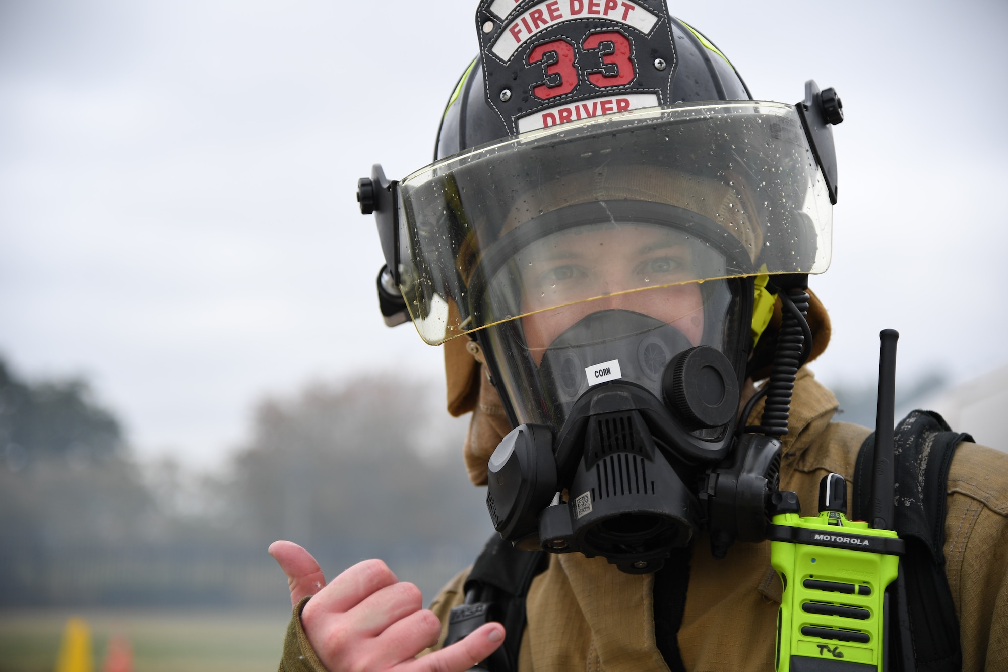 Seth Corn, 81st Infrastructure Division firefighter, poses for a photo after extinguishing a fire inside a mock C-123 training device during an aircraft rescue fire fighting training exercise at Keesler Air Force Base, Mississippi, Nov. 8, 2019. The five-day joint agency training allowed the Keesler Fire Department and the Gulfport Combat Readiness Training Center Fire Department to meet the semi-annual training requirement to practice aircraft rescue and live fire training evolutions. (U.S. Air Force photo by Kemberly Groue)