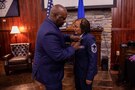 Retired U.S. Air Force Senior Master Sgt. Adrienne Smith is presented a meritorious service medal by retired Chief Master Sgt. Michael Brown during her retirement ceremony at the U.S. Army Transportation Museum. Smith retired after nearly 34 years of service in the U.S. Air Force Reserves. (DOD photo by Mass Communication Specialist 3rd Class Michael Redd/RELEASED)