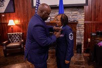 Retired U.S. Air Force Senior Master Sgt. Adrienne Smith is presented a meritorious service medal by retired Chief Master Sgt. Michael Brown during her retirement ceremony at the U.S. Army Transportation Museum. Smith retired after nearly 34 years of service in the U.S. Air Force Reserves. (DOD photo by Mass Communication Specialist 3rd Class Michael Redd/RELEASED)