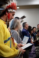 Chief Matthew Black Eagle Man reads his award given to him for his participation in the Fort Knox National American Indian Heritage Month Observance held at the Saber and Quill on Fort Knox, Ky. Nov. 15, 2019.