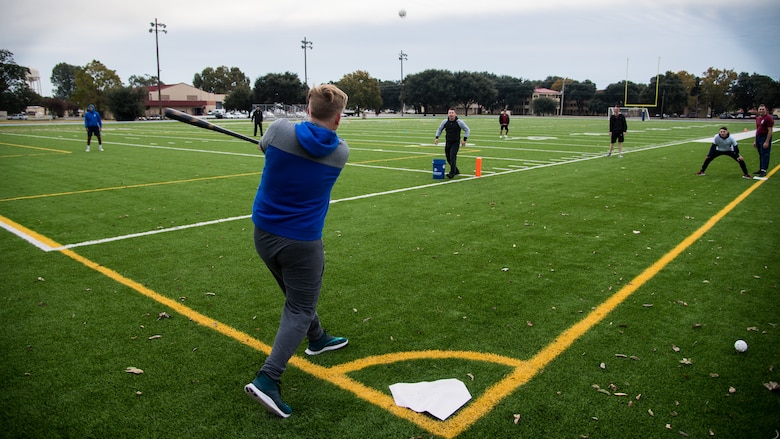 Airmen play a game of whiffle ball