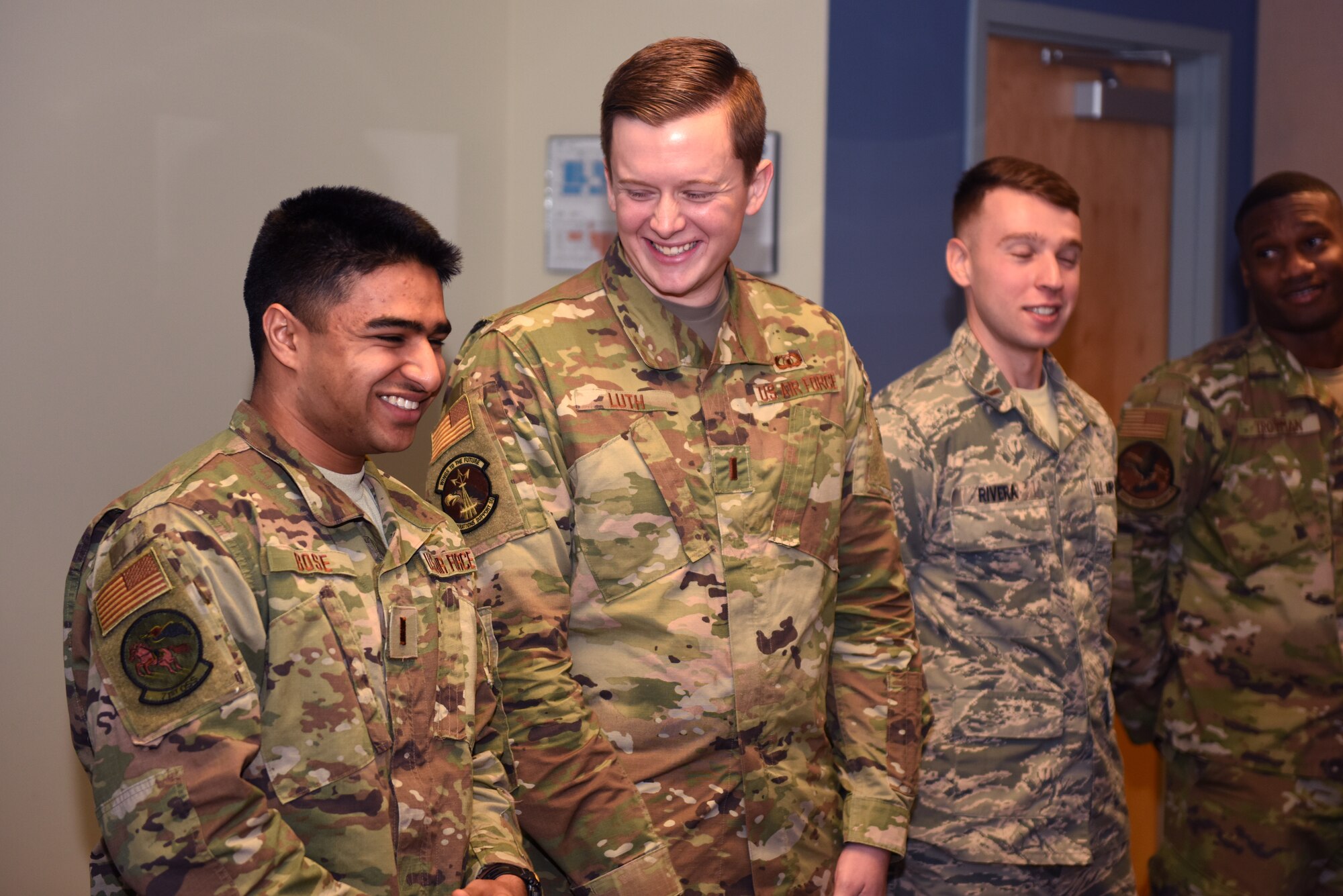 U.S. Air Force 2nd Lt. Kiefer Luth, 334th Training Squadron student, laughs with classmates before an Airfield Operations Officer Course graduation inside the Dempsey Conference Room inside Cody Hall at Keesler Air Force Base, Mississippi, Nov. 8, 2019. Luth recently completed the course and graduated in the room dedicated to his grandfather, retired Col. Derrel Dempsey. The room was dedicated to Dempsey to honor his military accomplishments. (U.S. Air Force photo by Airman Seth Haddix)