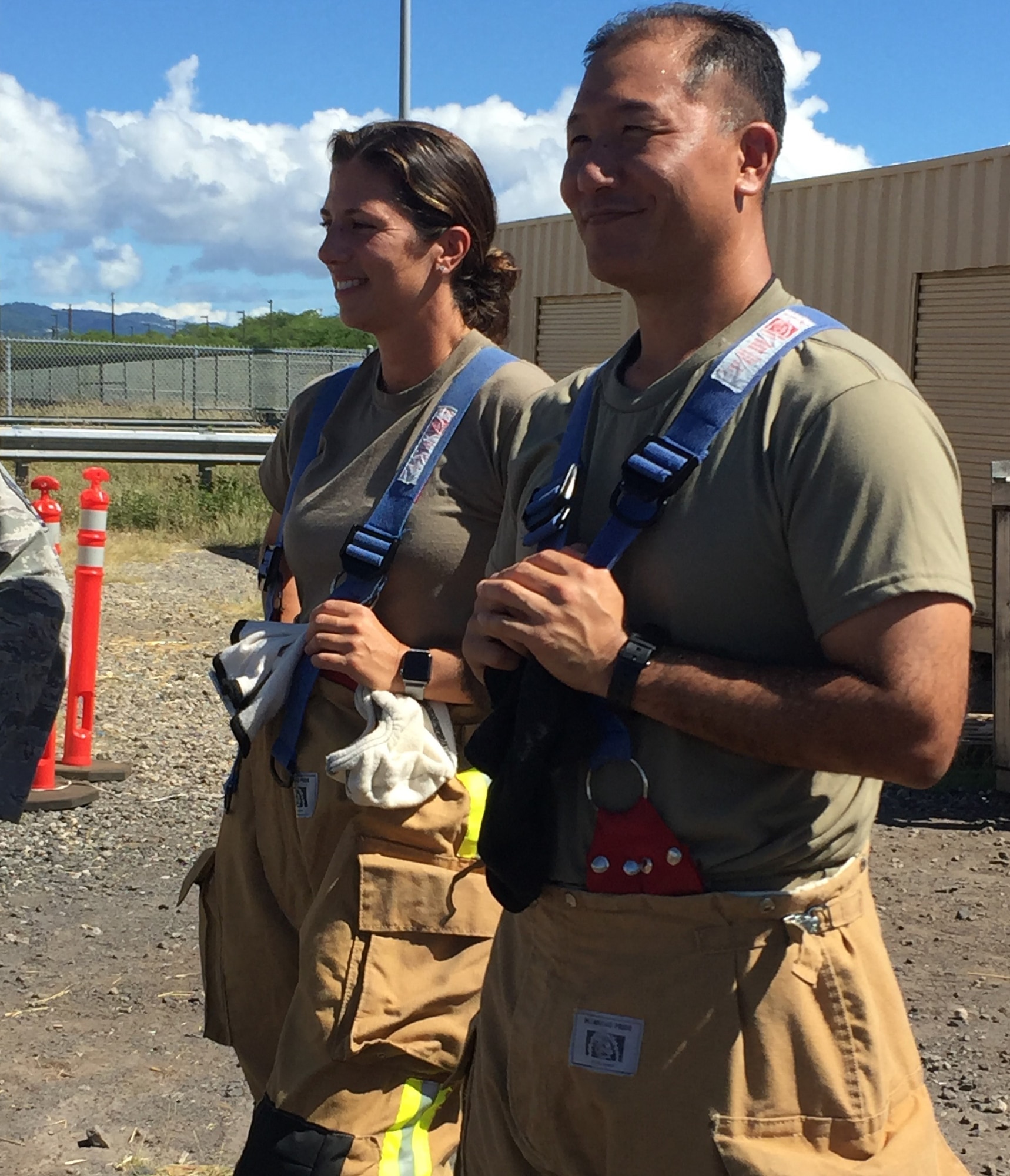 U.S. Air Force Col. Athanasia Shinas, 624th Regional Support Group commander, and Lt. Col. Reid Matsuda, 624th Civil Engineer Squadron commander, participate during the 624th CES firefighting team’s hands-on training Nov. 2 at the Joint Base Pearl Harbor-Hickam Fire Department Training Area. The required annual external Aircraft Rescue Firefighting training scenario prepares firefighter teams for real-world responses and missions. (U.S. Air Force courtesy photo)
