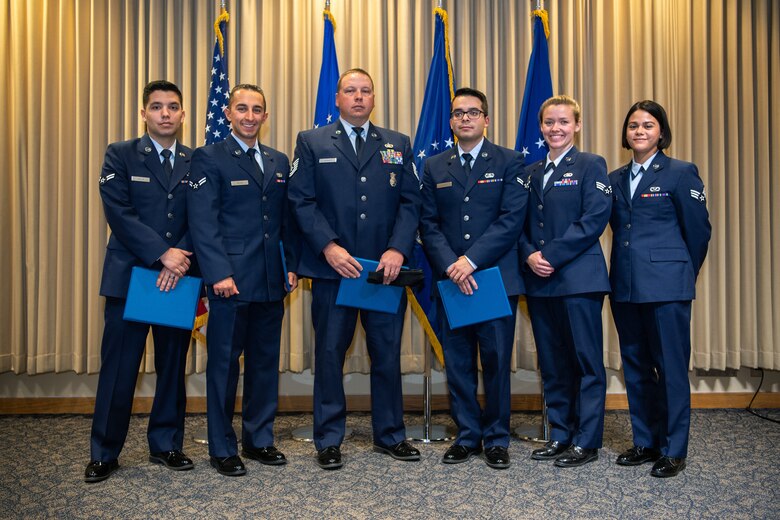SCHRIEVER AFB, Colo. - Team Schriever Community College of the Air Force graduates after receiving their diplomas, at Schriever Air Force Base, Colorado, Nov. 14,2019. The CCAF, through the Air University, was established in 1972 for Airmen to gain academic accreditation for training receiving in Air Force technical schools. ( U.S. Air Force photo by Kathryn Calvert)