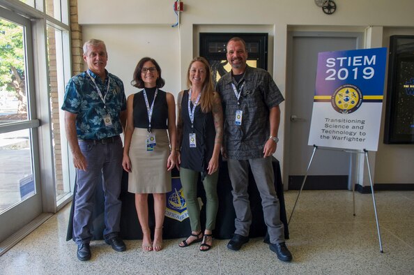 Dr. Jeffrey Sanders, Pacific Air Forces (PACAF) chief scientist, Katelyn McIlvaine, PACAF Booz Allen Hamilton senior consultant, Jessi Duval, PACAF Booz Allen Hamilton multi-lateral engagement coordinator, and Keith Miller, from PACAF Strategic Plans, Requirements and Programs, pose for a group photo during the Science and Technology Information Exchange Meeting registration at the base theater on Joint Base Pearl Harbor Hickam, Hawaii, Nov. 4, 2019. Exchanges such as these allow for open collaboration among the nation’s forward thinkers in uniform, academia and industry and help to transform the Air Force into the force of the future. (U.S. Air Force photo by Staff Sgt. Mikaley Kline)