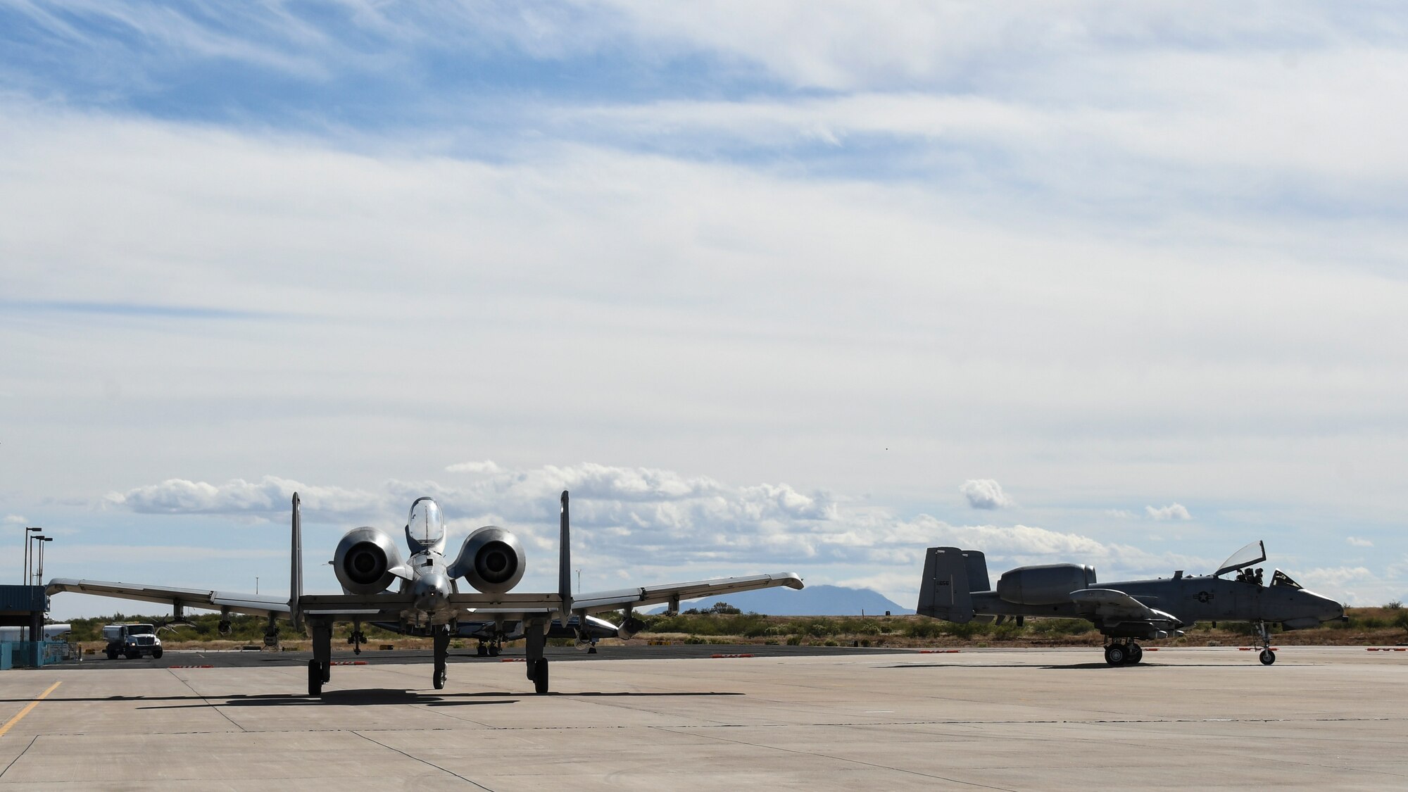 A photo of two A-10s taxiing on the runway.