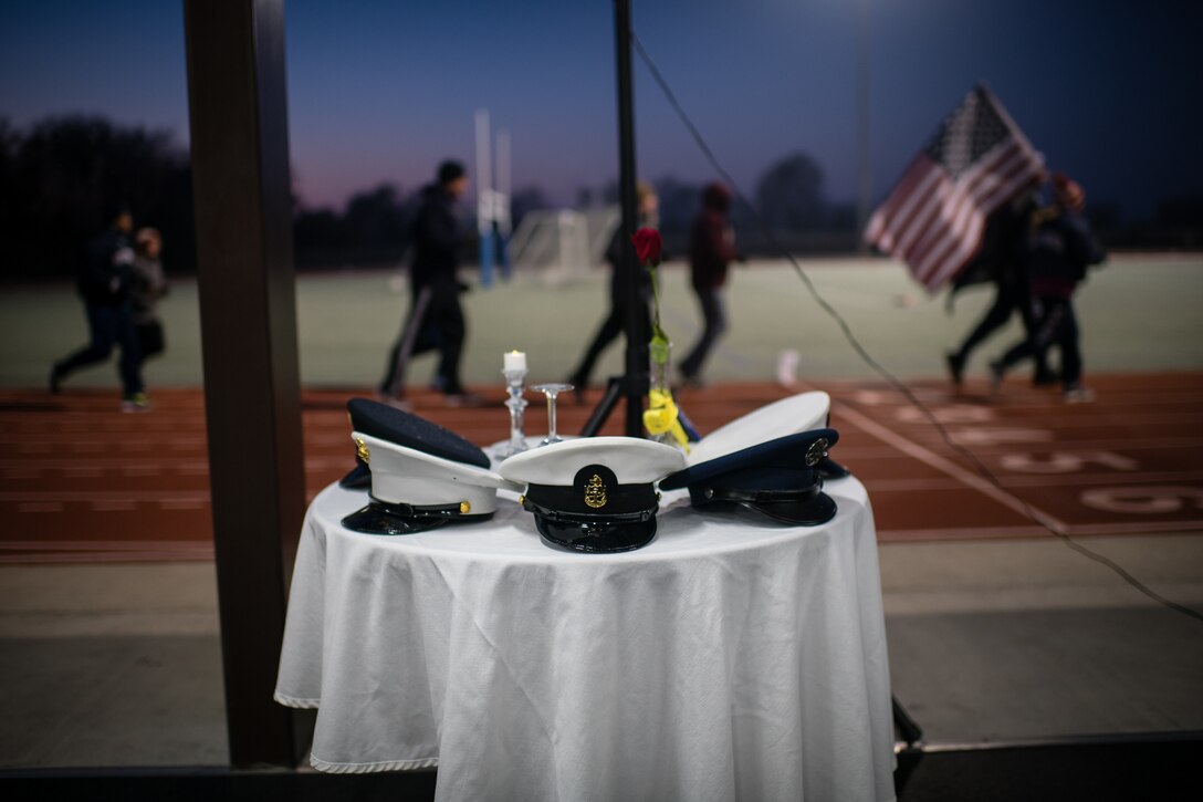 U.S. Air Force Reserve Citizen Airmen from the 932nd Airlift Wing keep the American and POW/MIA flags moving around the James Gym track during the 10th Annual Air Force Sergeants Association POW/MIA Vigil Run, Nov. 15, 2019, Scott Air Force Base, Illinois. The run/walk honors all POW/MIAs as the flag is carried for 24 hours.  The cold temperatures were visible in the cold breaths and frost on the flags but that didn't stop the flags from continually moving.   (U.S. Air Force photo by Christopher Parr)