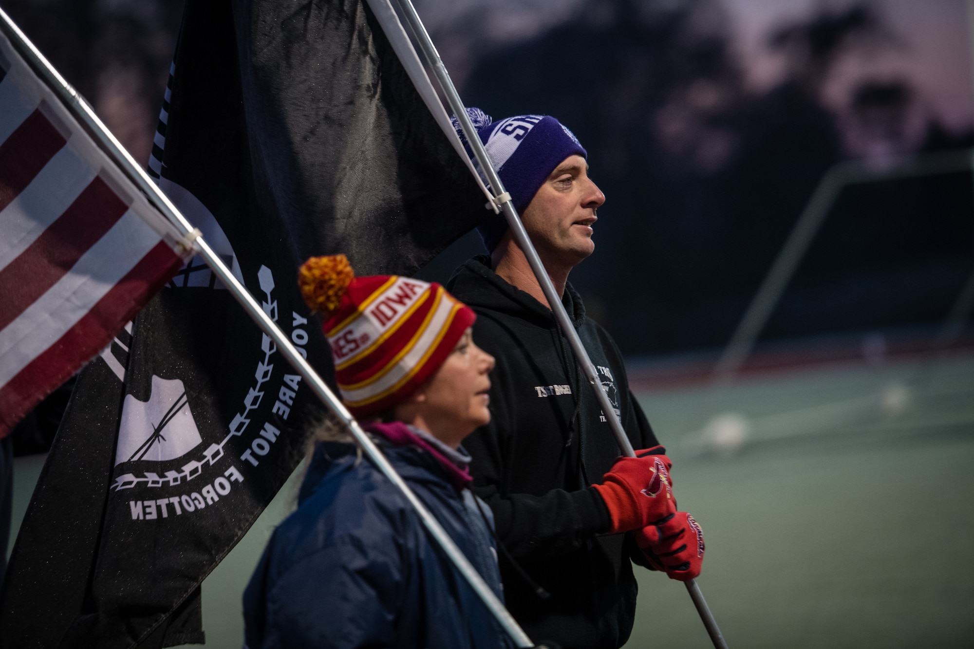 U.S. Air Force Reserve Citizen Airmen from the 932nd Airlift Wing keep the American and POW/MIA flags moving around the James Gym track during the 10th Annual Air Force Sergeants Association POW/MIA Vigil Run, Nov. 15, 2019, Scott Air Force Base, Illinois. The run/walk honors all POW/MIAs as the flag is carried for 24 hours.  The cold temperatures were visible in the cold breaths and frost on the flags but that didn't stop the flags from continually moving.   (U.S. Air Force photo by Christopher Parr)