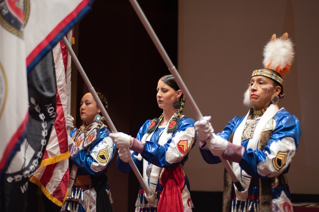 Three members of the Native American Women Warriors render honors during a vocal performance of “The Star-Spangled Banner” at the National American Indian Heritage Month observance at Redstone Arsenal, Alabama, Nov. 13, 2019. From left: Army veteran Keshon Smith; Marine Corps veteran Carrie Lewis; and Army veteran Mitchelene BigMan, president and founder of NAWW. The observance was organized by Huntsville Center’s Equal Employment Opportunity office in coordination with Team Redstone and the U.S. Army Aviation and Missile Command. The Native American Women Warriors are an all-female group of Native American veterans who started as a color guard but have since grown and branched out as advocates for Native American women veterans in areas such as health, education and employment. The members make appearances at various events around the country, serving as motivational and keynote speakers, performing tribal dances, and fulfilling the role of color guard representing all branches of the U.S. military.