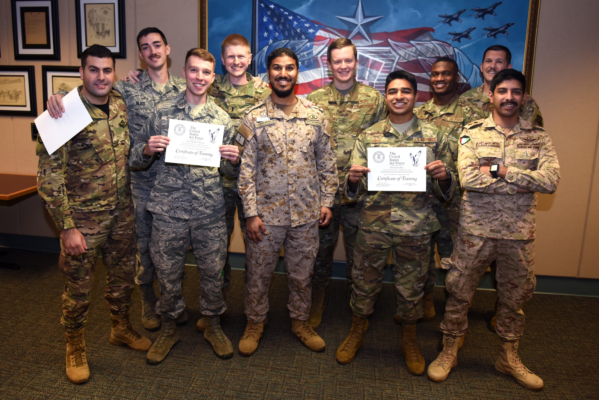 An Airfield Operations Officer Course class poses for a picture during an Airfield Operations Officer Course graduation inside the Dempsey Conference Room inside Cody Hall at Keesler Air Force Base, Mississippi, Nov. 8, 2019. U.S. Air Force 2nd Lt. Kiefer Luth, 57th Operations Support Squadron, Nellis Air Force Base, Nevada, airfield operations officer, recently completed the course and graduated in the room dedicated to his grandfather, retired Col. Derrel Dempsey. The room was dedicated to Dempsey to honor his military accomplishments. (U.S. Air Force photo by Airman Seth Haddix)