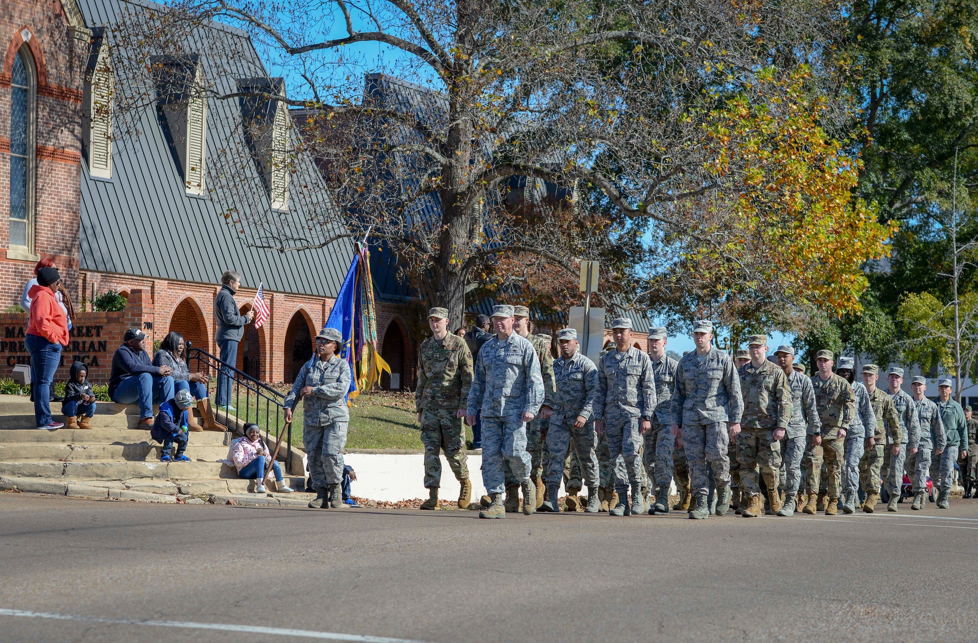 Members of the 14th Flying Training Wing march down Main Street in Columbus, Miss., during the Columbus Veterans Day Parade Nov. 9, 2019. Airmen representing all groups within Team BLAZE on Columbus Air Force Base, Miss., were a part of the flight. (U.S. Air Force photo by Tech. Sgt. Christopher Gross)
