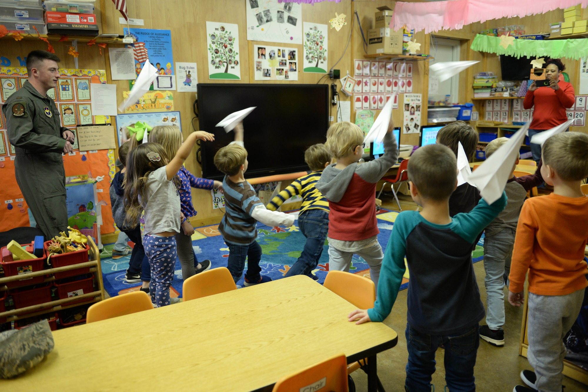 Second Lt. Brett Herring, 14th Student Squadron student pilot, watches as children throw paper airplanes Nov. 8, 2019, at Lil’ Blessings child care center in Hamilton, Miss. Herring visited the children to answer their questions about the military prior to Veterans Day. (U.S. Air Force photo by Airman 1st Class Hannah Bean)