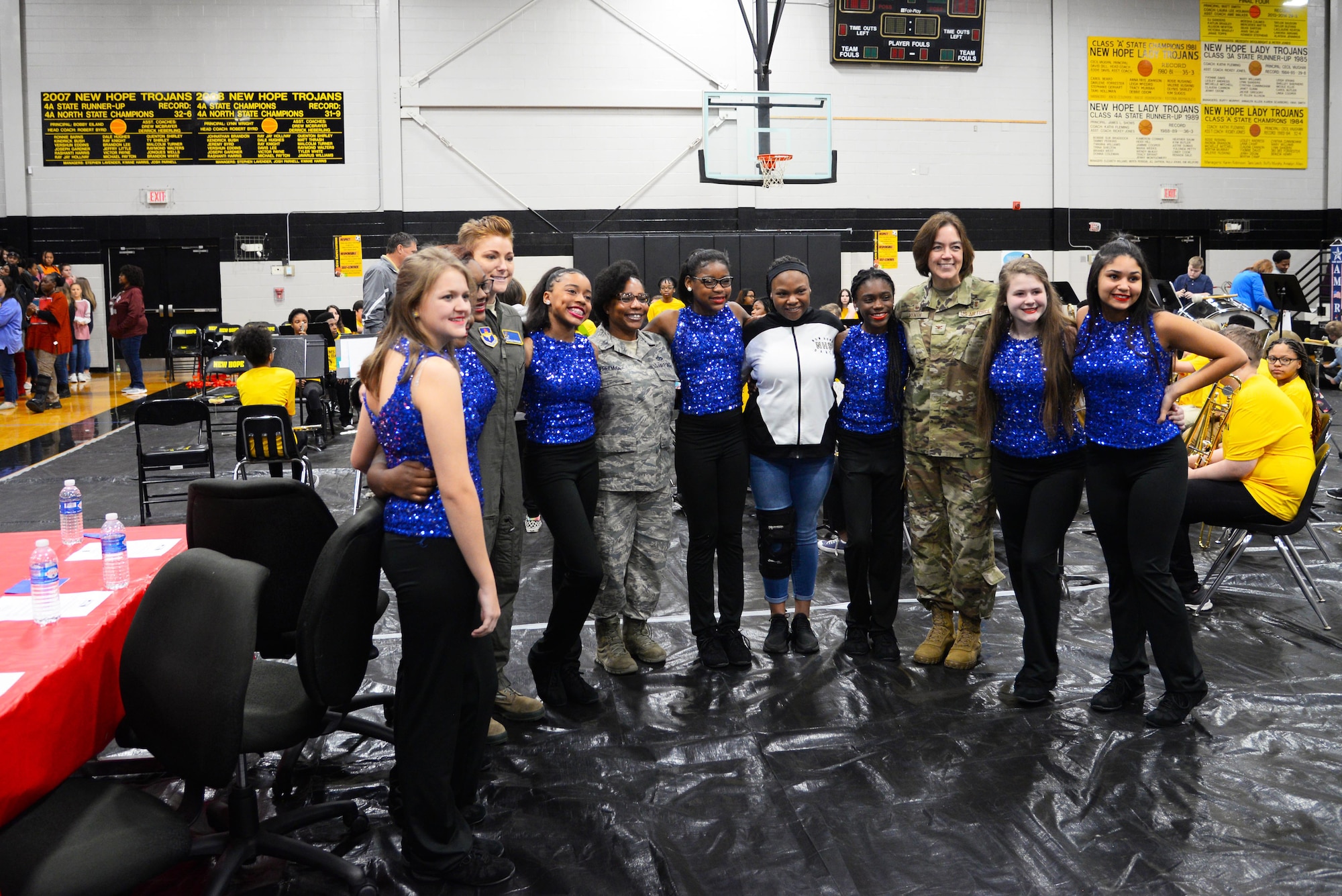 Col. Betty Venth, Medical Group commander, 2nd Lt. Michelle Strickland, 37th Flying Training Squadron student pilot, and Master Sgt. Beverly Freeman, Mission Support Group first sergeant, stand with a group of girls from New Hope middle school, Nov. 8, 2019, Columbus, Miss. After the questions and answers part of the visit, the three female veterans stuck around to meet and talk with some of the students at the school. (U.S. Air Force photo by Airman 1st Class Jake Jacobsen)