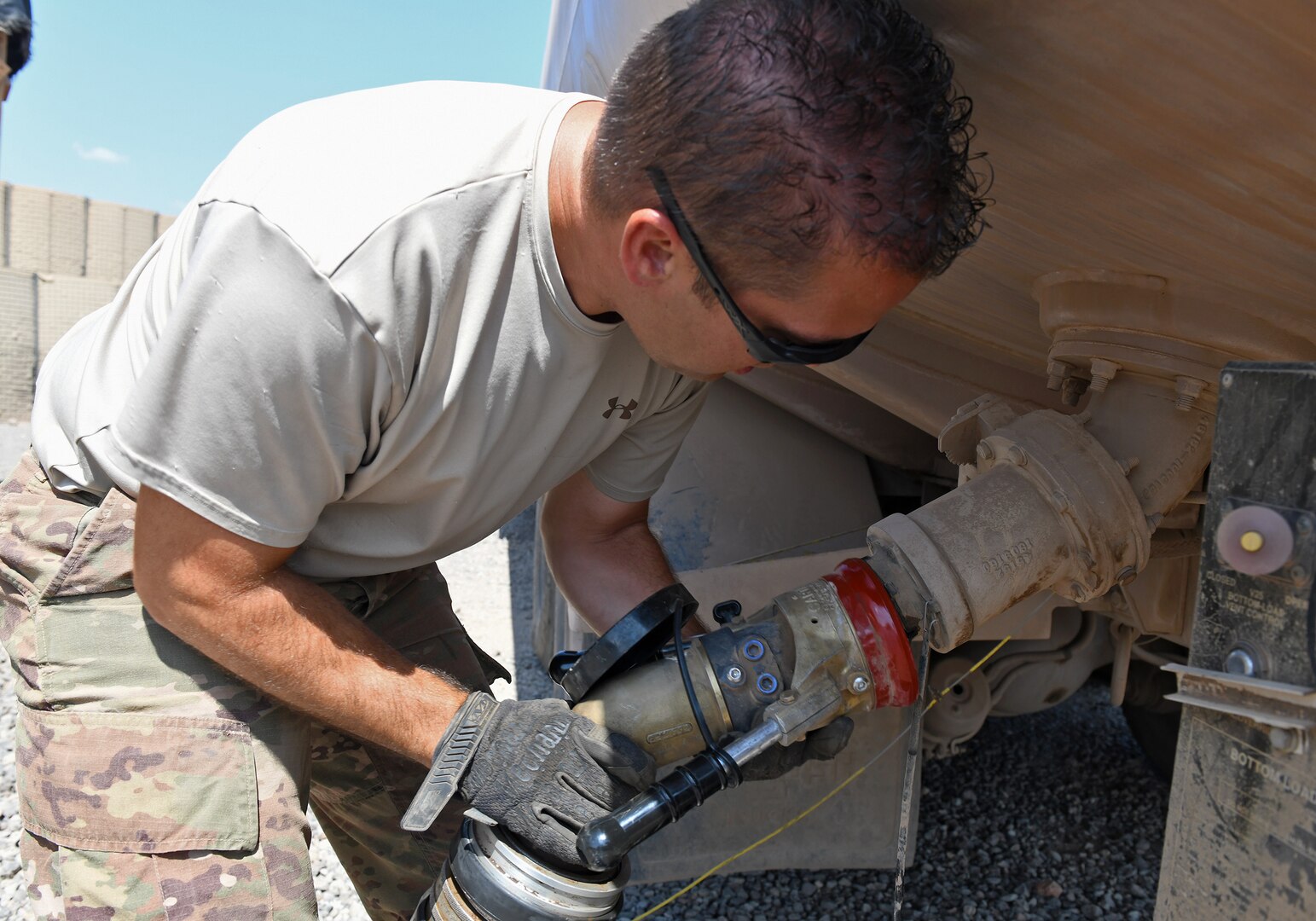 U.S. Air Force Tech. Sgt. James Hopper, 726th Expeditionary Air Base Squadron Vehicle Maintenance flight chief, connects the master meter to an R11 refueling truck to calibrate the fuel flow at Chabelley Airfield, Djibouti, Nov. 8, 2019. The 726th EABS Vehicle Maintenance team members service and repair more than 140 Air Force vehicles in the Horn of Africa area of responsibility. (U.S. Air Force photo by Staff Sgt. Alex Fox Echols III)