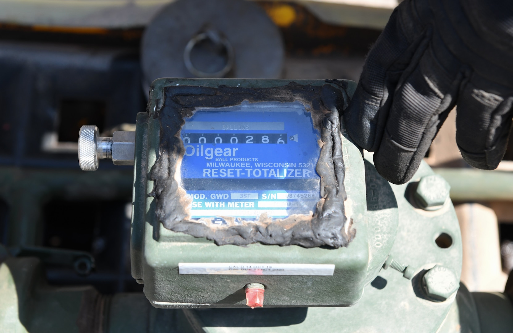 U.S. Air Force Master Sgt. Larry Davidson, 776th Expeditionary Air Base Squadron Fuels superintendent, checks the master meter during the meter calibration of an R11 refueling truck at Chabelley Airfield, Djibouti, Nov. 8, 2019. The master meter is the benchmark used to set the tanker’s onboard meter ensuring the proper amount of fuel is flowing during calibration. (U.S. Air Force photo by Staff Sgt. Alex Fox Echols III)
