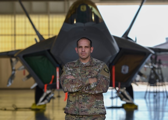 U.S. Air Force Tech. Sgt. Daniel Caban, 1st Aircraft Maintenance Squadron crew chief, covers an F-22 Raptor intake with the Portable Magnetic Aircraft Covers at Joint Base Langley-Eustis, Virginia, Oct. 23, 2019.