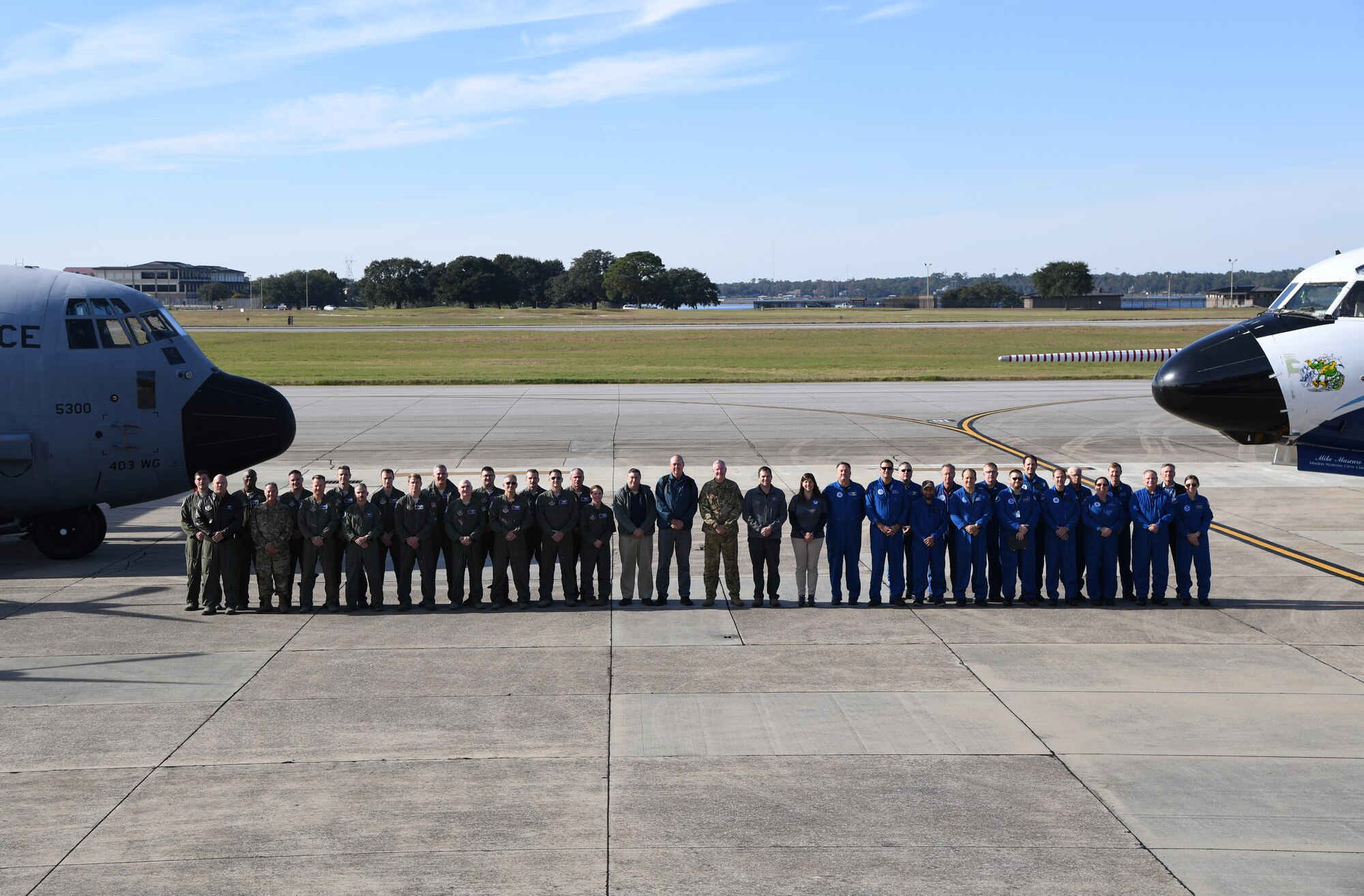 Members from the 53rd Weather Reconnaissance Squadron National Oceanic and Atmospheric Administration, National Hurricane Center, National Center for Atmospheric Research and the Chief, Aerial Reconnaissance Coordination, All Hurricanes pose for a group photo Nov. 13, 2019 on the flightline at Keesler, Air Force Base, Miss.