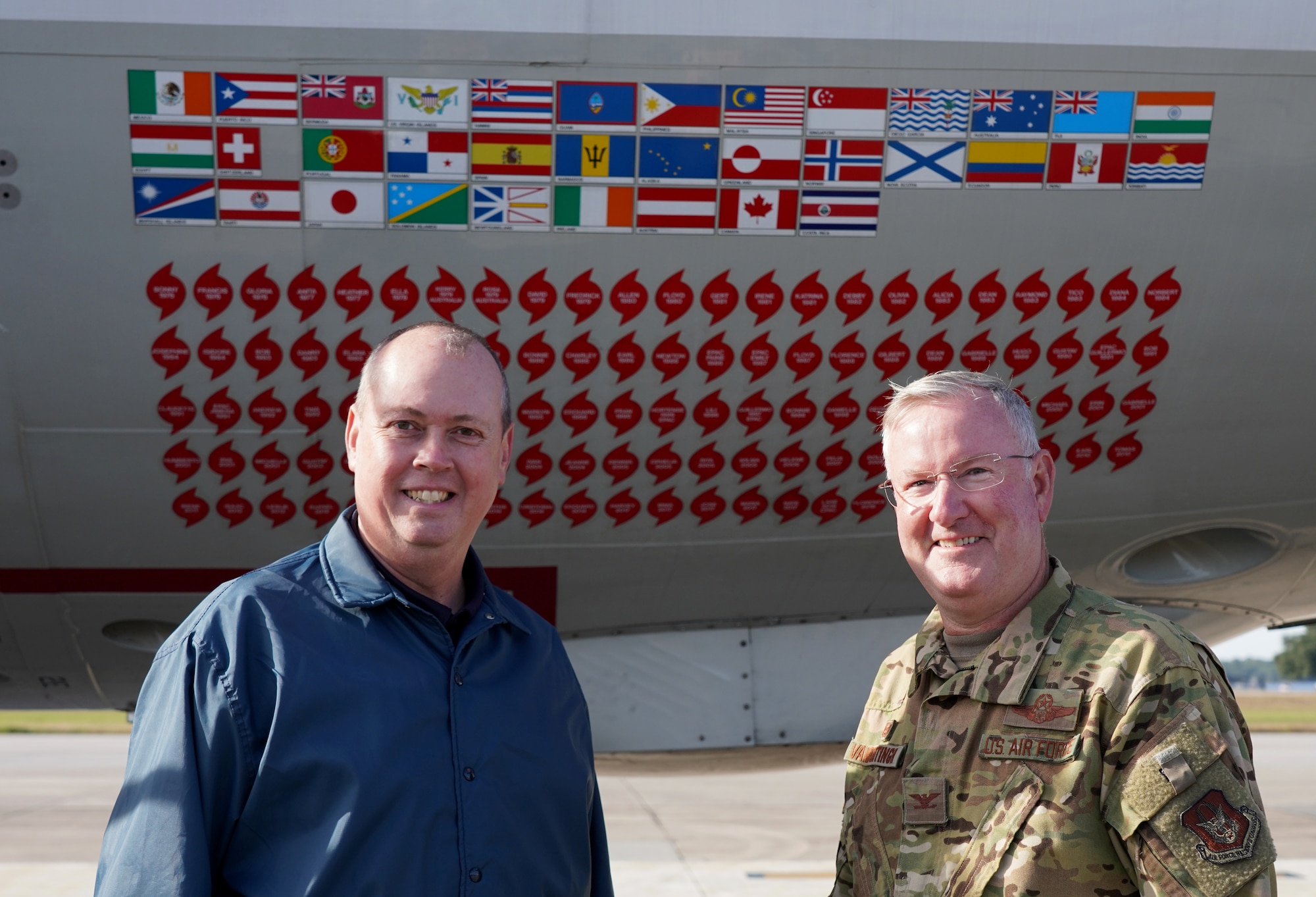 Ken Graham, director of the National Hurricane Center in Miami, and Col. Jeffrey A. Van Dootingh, 403rd Wing commander, pose for photo in front of a WP-3D Orion at Keesler Air Force Base Nov. 13, 2019. The aircraft is used by the National Oceanic and Atmospheric Administration's Aircraft Operations Center Hurricane Hunters to fly into hurricanes. (U.S. Air Force photo by Senior Airman Kristen Pittman)