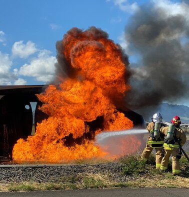 U.S. Air Force Col. Athanasia Shinas, 624th Regional Support Group commander, and Lt. Col. Reid Matsuda, 624th Civil Engineer Squadron commander, work together to put out a fire during the 624th CES firefighting team’s hands-on training Nov. 2 at the Joint Base Pearl Harbor-Hickam Fire Department Training Area. Group leadership joined the firefighting team during their required annual external Aircraft Rescue Firefighting training scenario, which prepares teams for real-world responses and missions. (U.S. Air Force courtesy photo)