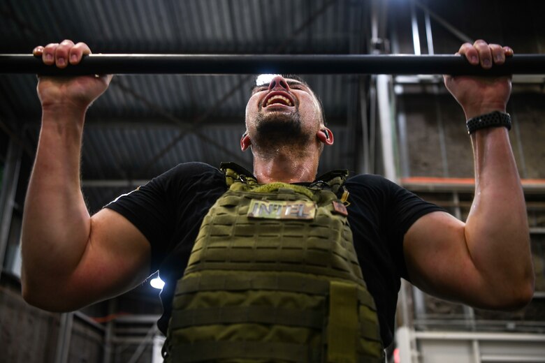 Staff Sgt. attempts to complete a pullup during a “Murph” workout