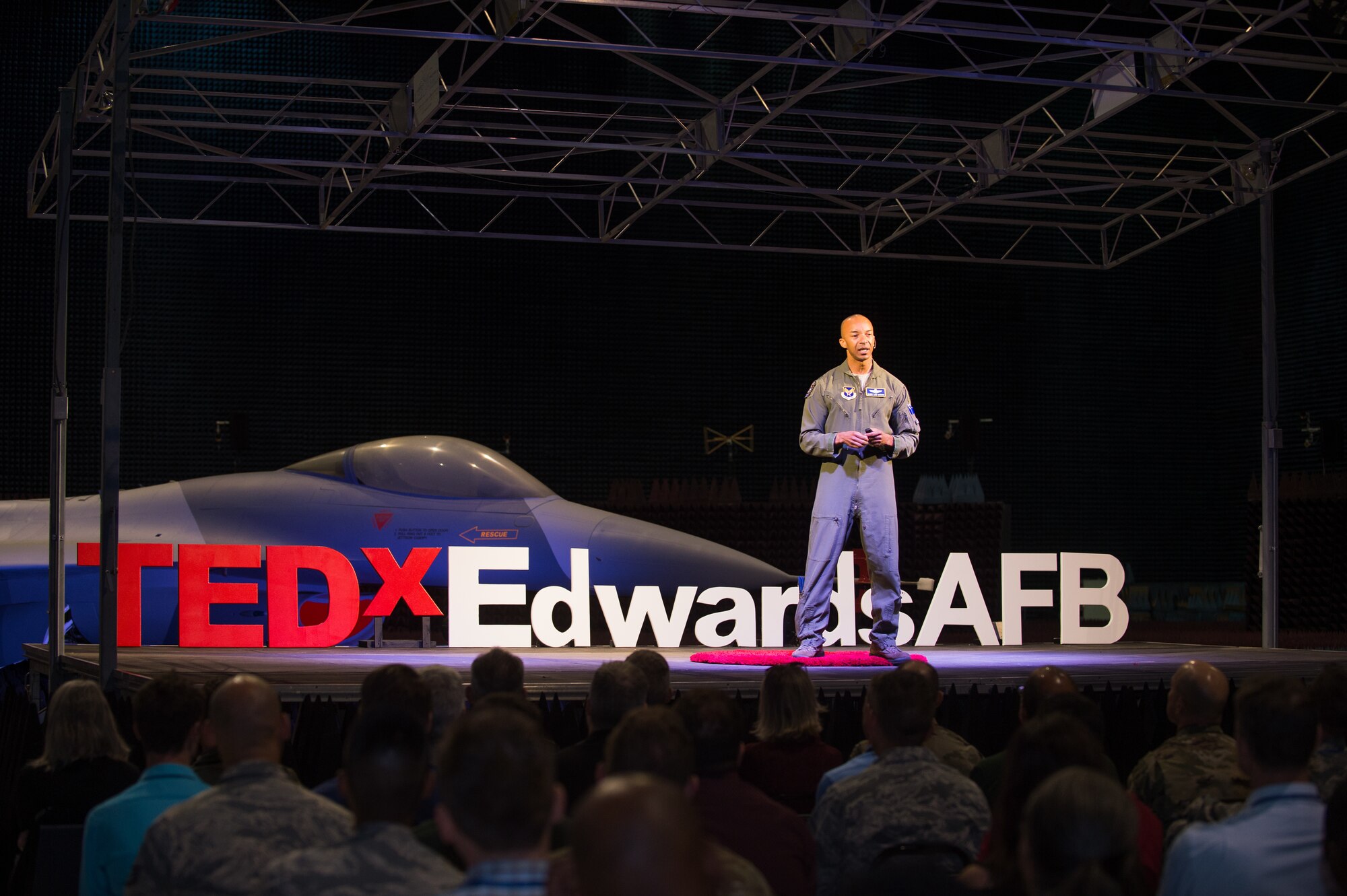 Col. Randy “Laz” Gordon, Lead for the Secretary of the Air Force’s AI Technology Accelerator, talks to guests during a presentation at the Edwards Air Force Base first-ever TEDx talks in the Benefield Anechoic Facility at Edwards AFB, California, Nov. 12. Gordon shared his experiences on innovation, implementation and breaking barriers while serving in the Air Force. Technology, Entertainment, and Design (TED) is a nonpartisan nonprofit devoted to spreading ideas, usually in the form of short, powerful talks. Meanwhile, TEDx events are organized independently under a free license granted by TED, according to the TED website. (Air Force photo by Richard Gonzales)