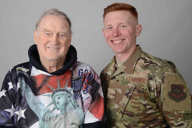 U.S. Air Force Retired Staff Sgt. Galen Eberhardt and his grandson, Airman 1st Class Douglas Bosarge, 22nd Operations Support Squadron airfield management shift lead, pose for a photo Nov. 13, 2019, at McConnell Air Force Base, Kan. Eberhardt was stationed at McConnell from 1970 to 1975, while Bosarge arrived at McConnell in 2018. (U.S. Air Force photo by Airman 1st Class Alexi Bosarge)