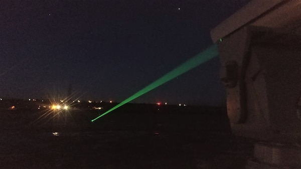 Photo of green laser shining at night