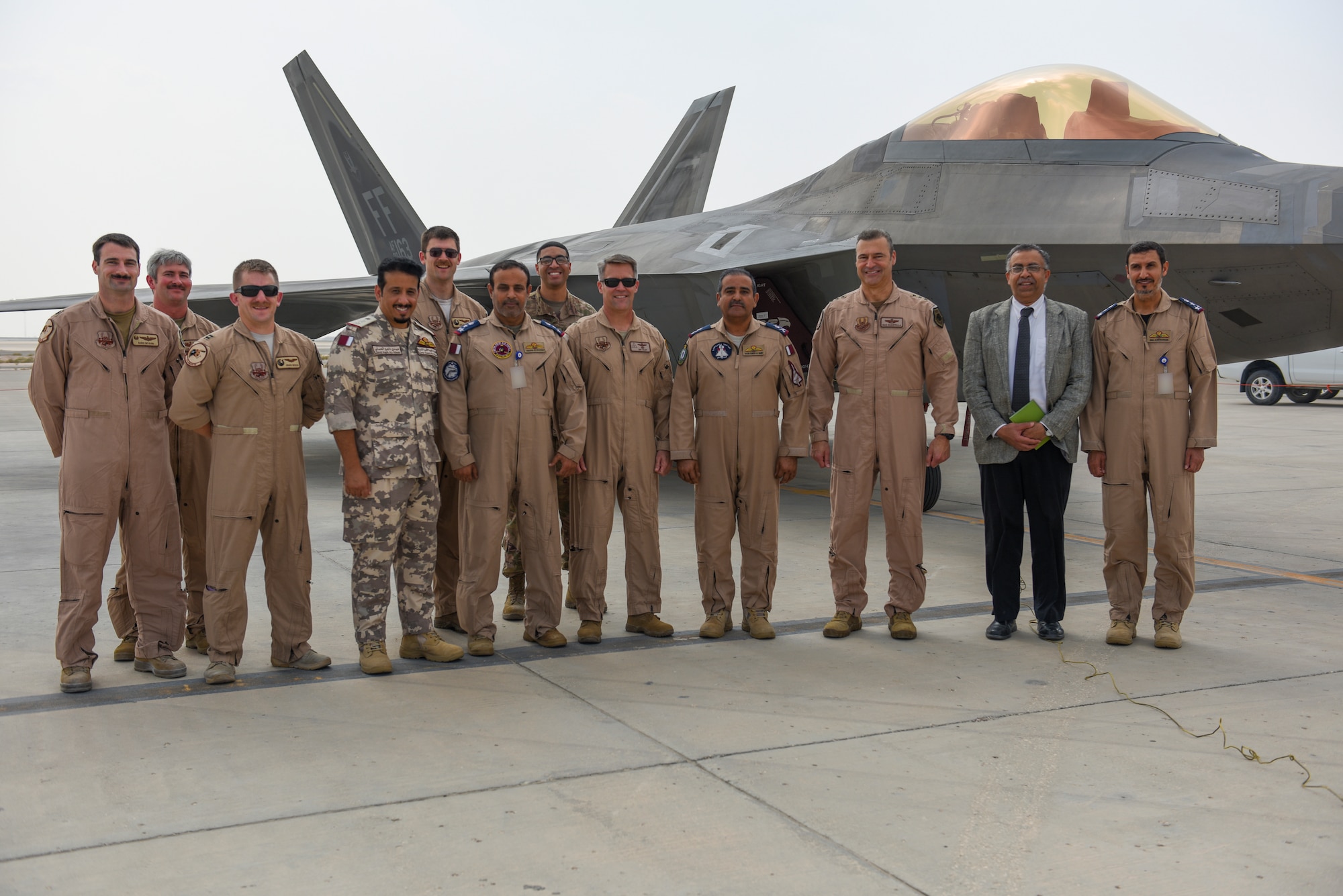 Qatar Emiri Air Force senior leaders, U.S. Air Forces Central Command senior leaders, and U.S. Air Force F-22 Raptor pilots pose for a group photo during a visit to Al Udeid Air Base Qatar, Nov 10, 2019.
