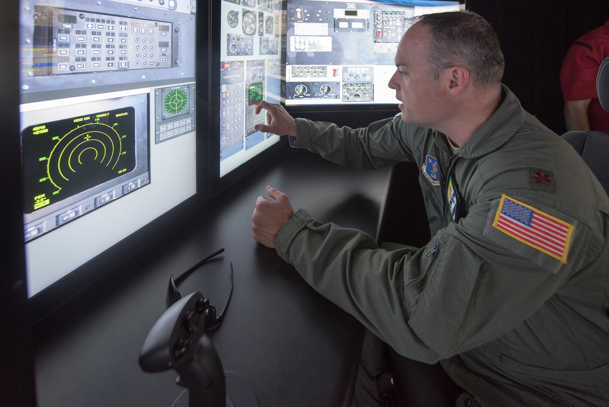 Maj. Bryan Keating, a navigator from the Kentucky Air National Guard’s 165th Airlift Squadron, uses touch panels on a C-130 simulator at the Kentucky Air National Guard Base in Louisville, Ky., Aug. 28, 2019. Known as the Multi-Mission Crew Trainer, the system helps prepare Airmen for handling in-flight emergencies. (U.S. Air National Guard photo by Phil Speck)