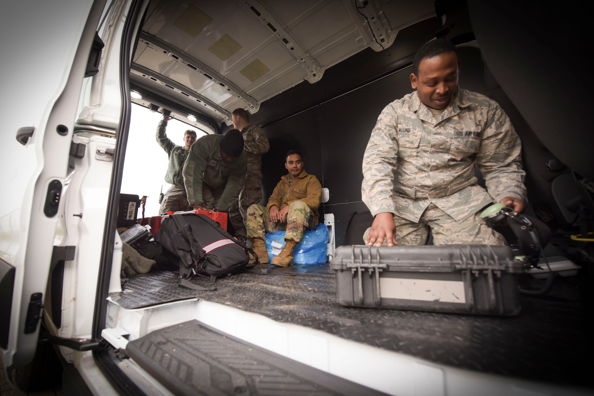 U.S. Air Force Airmen from the 100th Maintenance Squadron adjust their tools and create makeshift seats out of toolboxes in the empty bay at RAF Mildenhall, England, Oct. 28, 2019. When new trucks come to RAF Mildenhall to join the RIET ‘ready-made, integrated, expeditor truck’ line will have the updated Wi-Fi capability, gates, seats, and bay heating, and other attributes. (U.S. Air Force photo by Senior Airman Alexandria Lee)