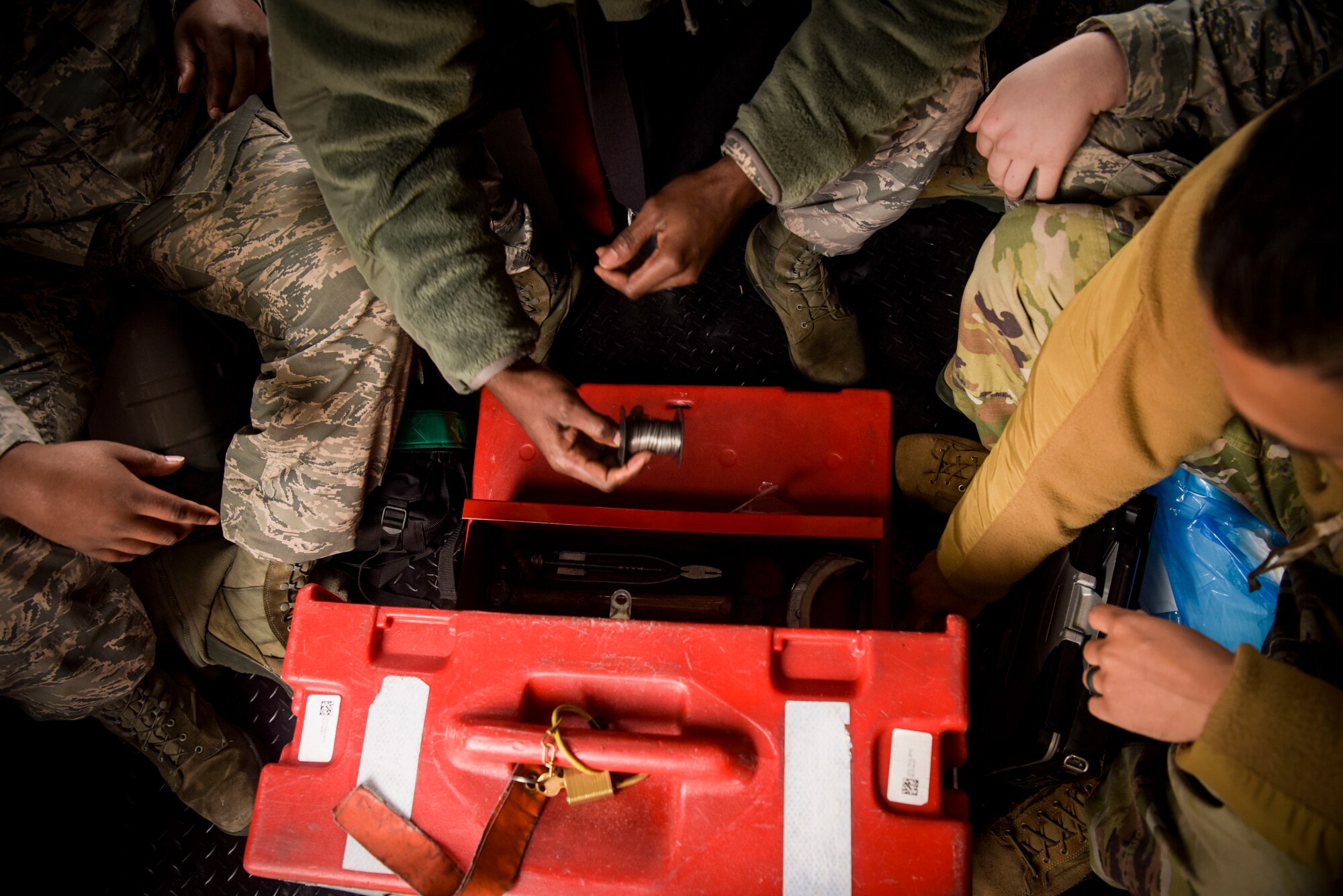 U.S. Air Force Airmen from the 100th Maintenance Squadron, reset their toolbox on the floor of the empty truck bay at RAF Mildenhall, England, Oct. 28, 2019. When new trucks come to RAF Mildenhall to join the RIET ‘ready-made, integrated, expeditor truck’ line will have the updated wifi capability, gates, seats, and bay heating, and other attributes. (U.S. Air Force photo by Senior Airman Alexandria Lee)