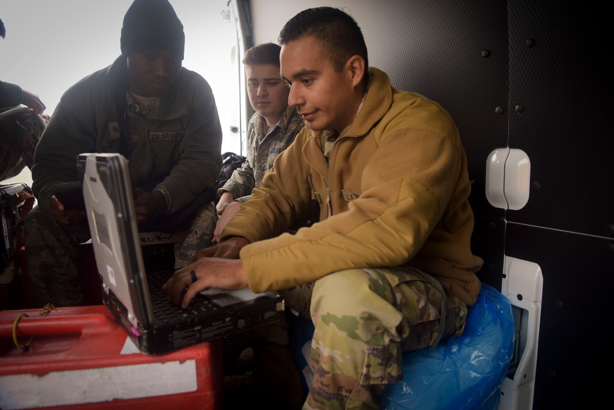 U.S. Air Force Staff Sgt. Adam Magdaleno, 100th Maintenance Squadron sortie support shift supervisor and vehicle control noncommissioned officer-in charge, sits on a makeshift desk and chair in an empty cargo van at RAF Mildenhall, England, Oct. 28, 2019. Team Mildenhall is submitting RIET – ‘ready-made, integrated, expeditor truck’ for Spark Tank 2020, It’s the first step to towards the flight line of the future. (U.S. Air Force photo by Senior Airman Alexandria Lee)