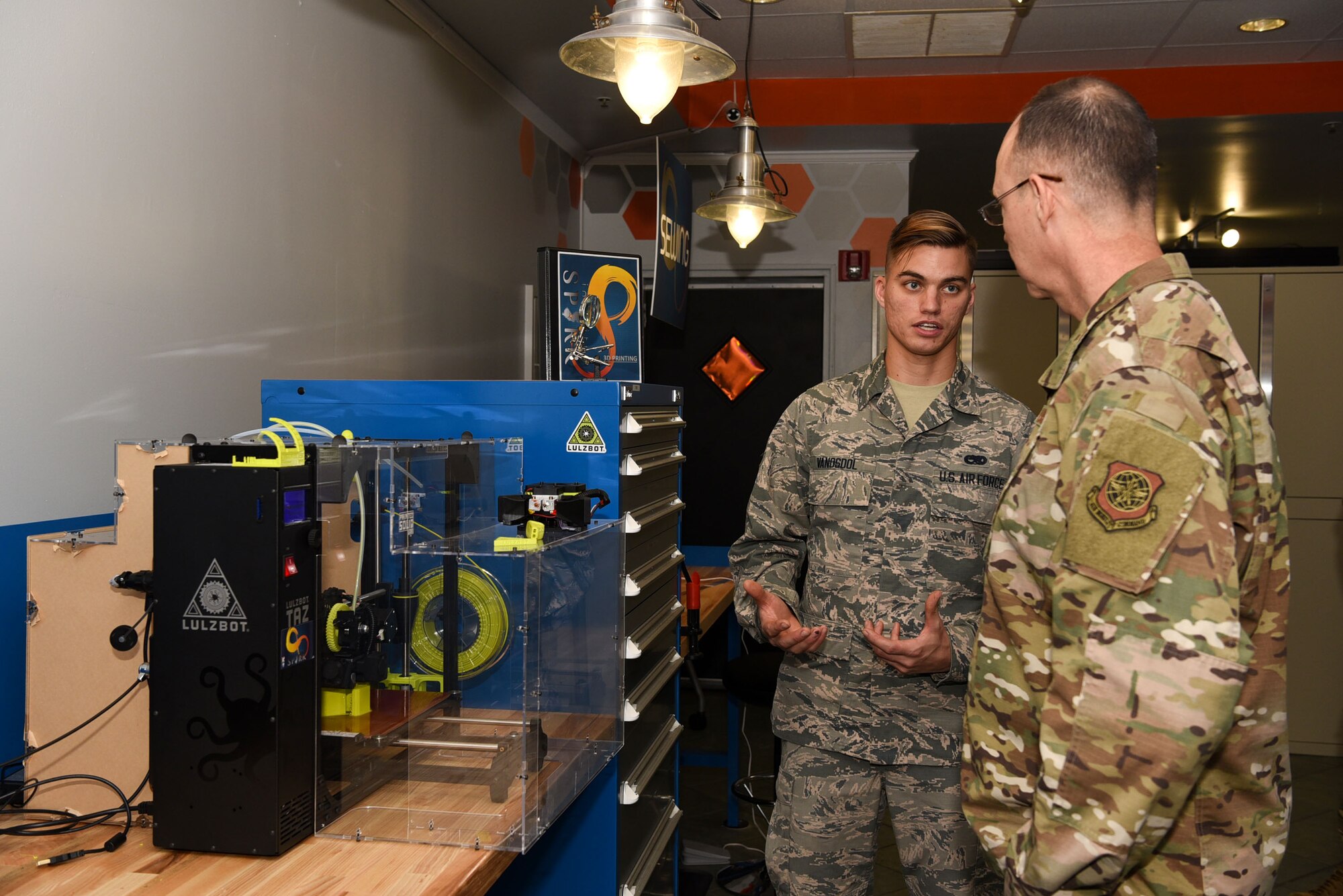 Airman 1st Class Evan Vanosdol, 305th Maintenance Squadron crew chief, showcases the Innovation Lab 3D printers to Brig. Gen. Richard W. Gibbs, Air Mobility Command, Logistics, Engineering and Force Protection director, at Joint Base McGuire-Dix-Lakehurst, N.J., Oct. 31, 2019. Vanosdol is currently interning at the Innovation Lab where he highlighted how Airmen from the 305th Air Mobility Wing have already implemented 3D printed equipment, proving to save thousands of dollars. (U.S. Air Force photo by Airman 1st Class Ariel Owings)