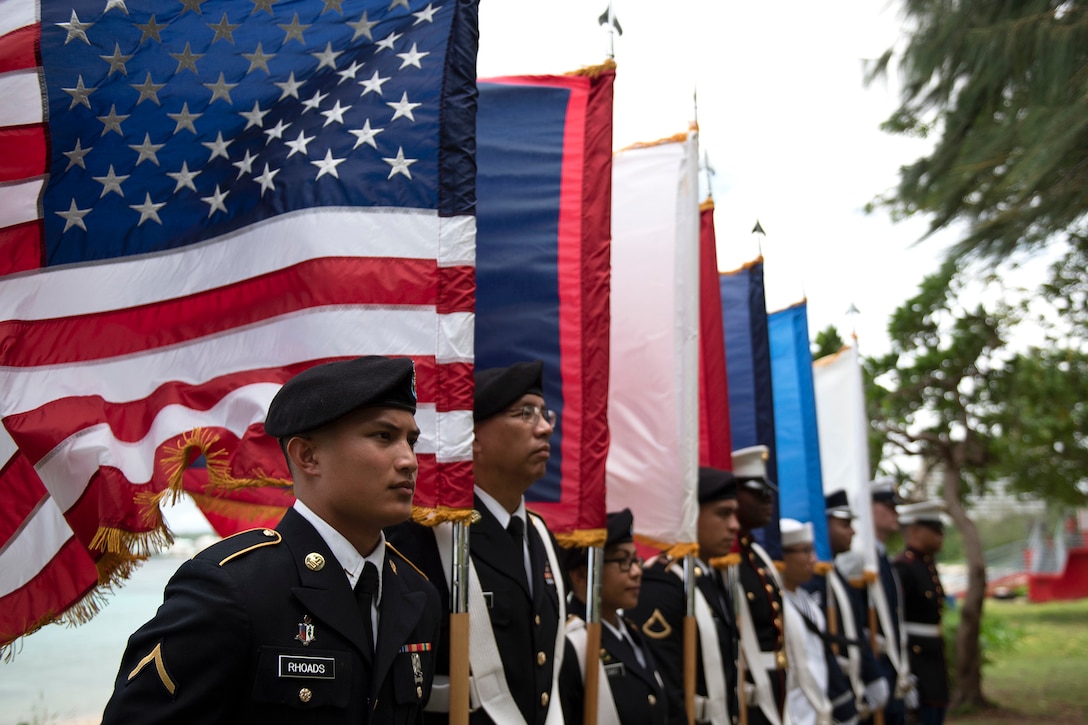 Members of a joint color guard stand in formation.