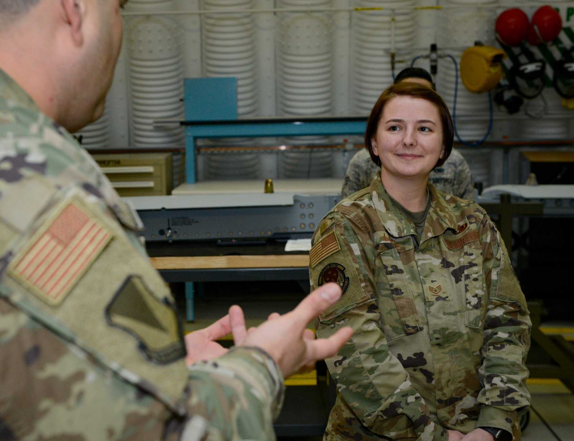U.S. Air Force Chief Master Sgt. Ernesto Rendon, left, 86th Airlift Wing command chief, lauds U.S. Air Force Staff Sgt. Tiffany Leese, 86th AW noncommissioned officer in charge of maintenance, during a gathering of her peers and leadership on Ramstein Air Base, Germany, Nov. 15, 2019. Leese epitomizes the core value of excellence for her superior work performance, to include maintaining the Air Force’s largest reserve aircraft armament equipment account worth more than $92 million.
