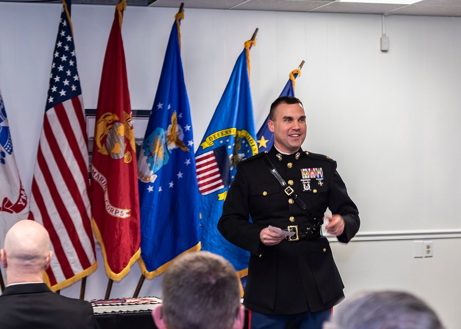 Man standing in front of flags