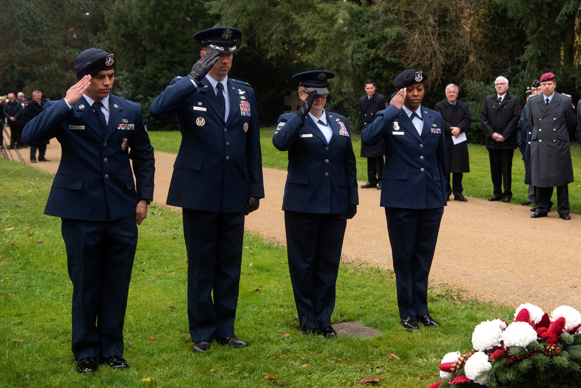 U.S. Air Force Col. David Epperson, 52nd Fighter Wing commander, center left, Chief Master Sgt. Stephanie Cates, 52nd FW command chief, center right, and Airmen from the 52nd Security Forces Squadron, render a salute in front of a memorial during the German National Day of Mourning ceremony at the Trier cemetery in Trier, Germany, Nov. 17, 2019. The 52nd SFS members laid a wreath at the base of the memorial. The annual ceremony honors victims of war and tyranny. (U.S. Air Force photo by Airman 1st Class Valerie Seelye)