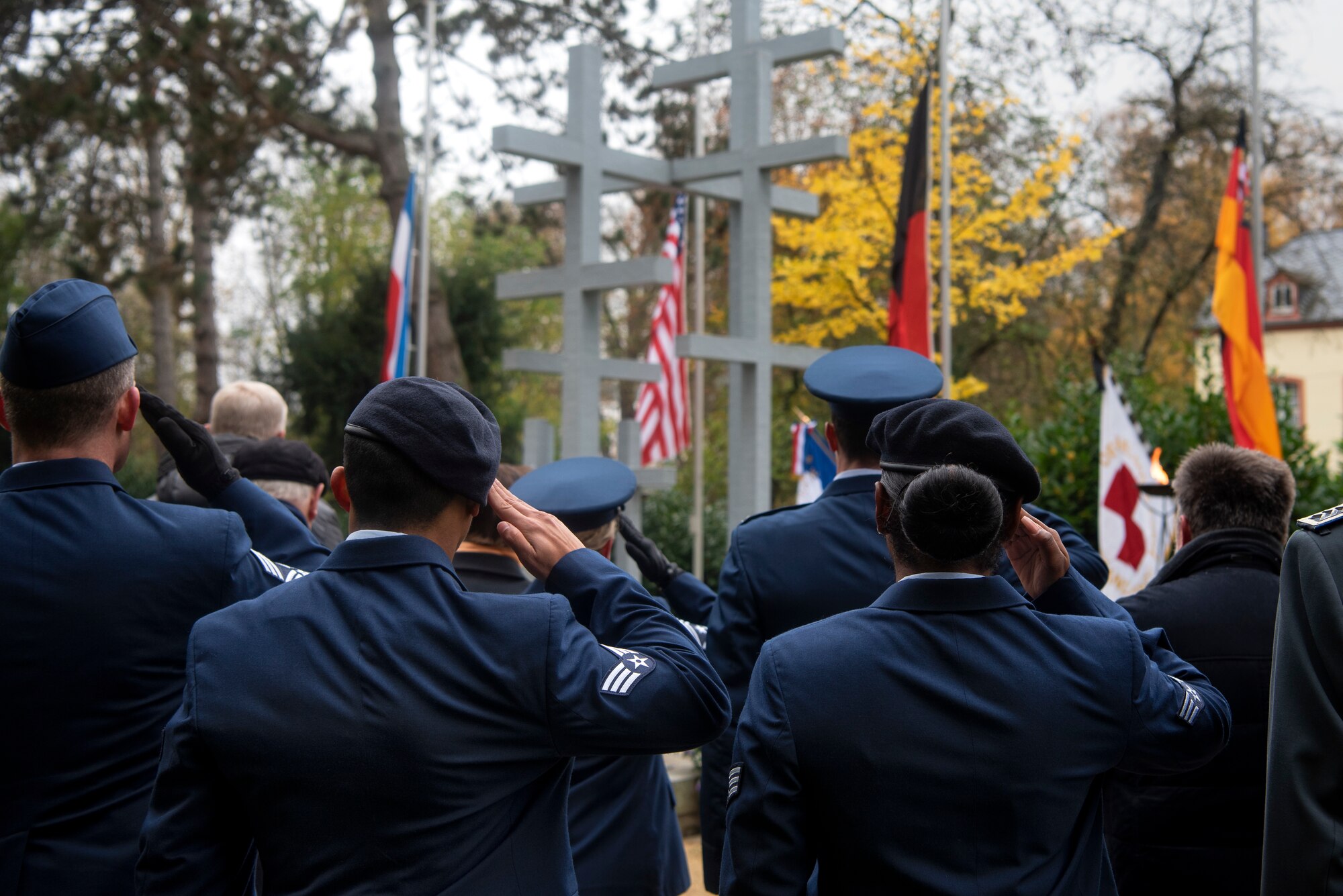 U.S. Air Force Airmen and leadership from the 52nd Fighter Wing render a salute during the German National Day of Mourning ceremony at the Trier cemetery in Trier, Germany, Nov. 17, 2019. A live band played the U.S. and German national anthems and attendees held a moment of silence. Germany established the annual observance at the conclusion of World War I, but the day now commemorates all those who have lost their lives in war. (U.S. Air Force photo by Airman 1st Class Valerie Seelye)